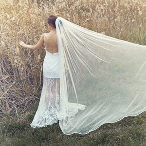 New never used cathedral length ivory veil with ribbon trim and comb